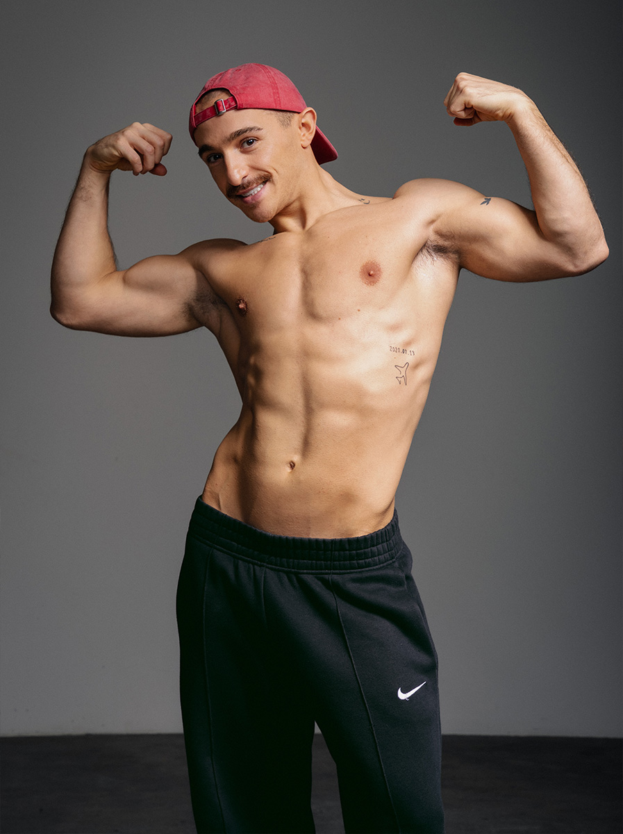 Coach is flexing both arms.